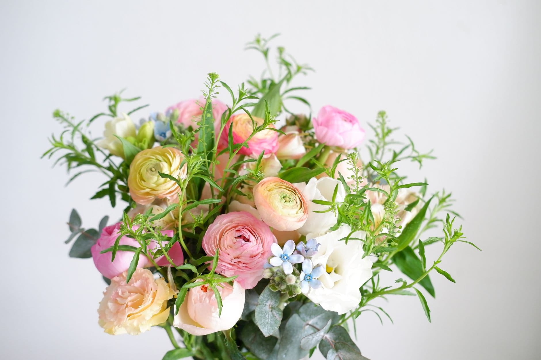 A vibrant bouquet of mixed flowers with greenery, perfect for romantic occasions.