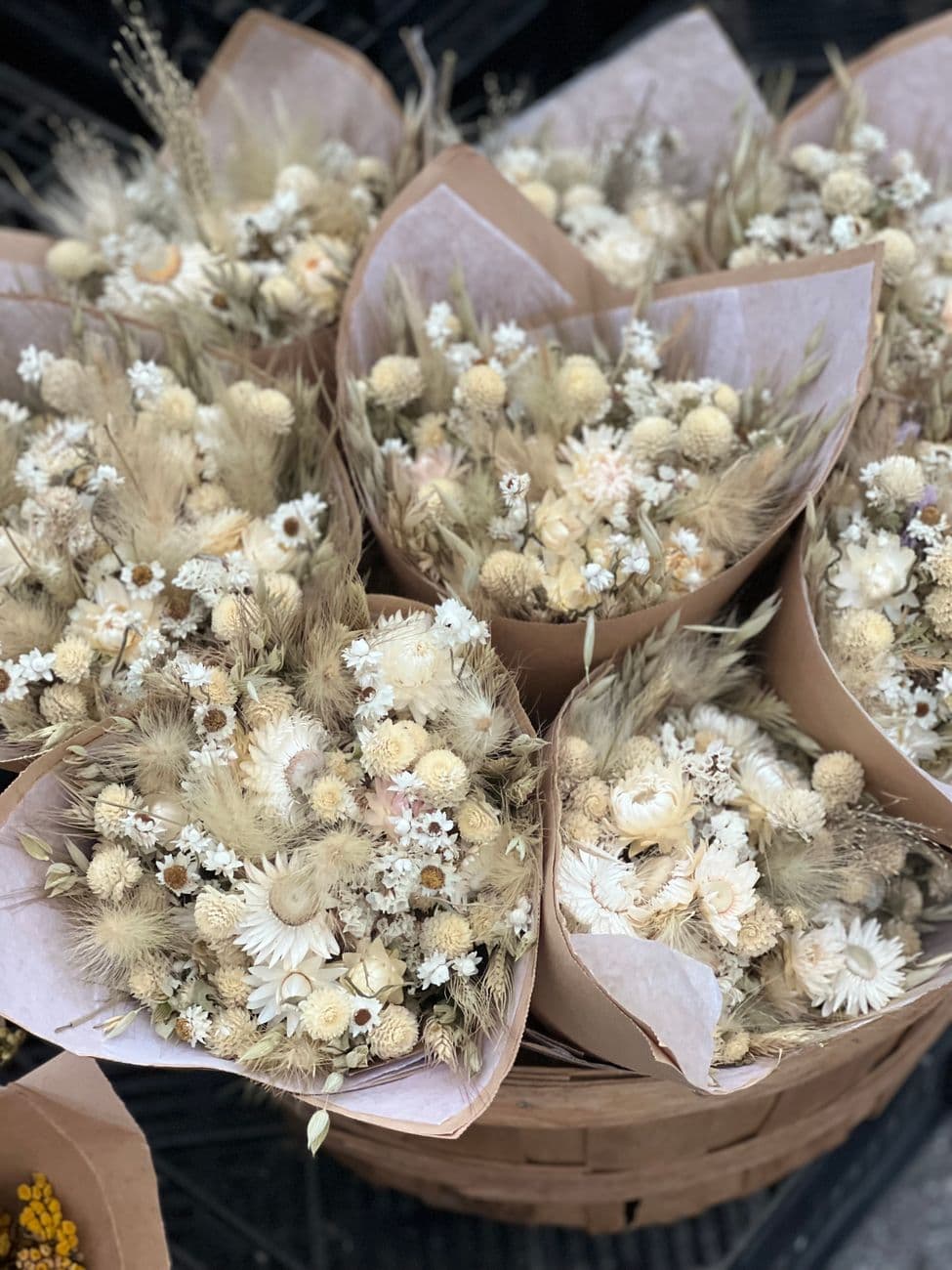 A collection of beautiful dried flower bouquets displayed in baskets, perfect for decor.